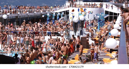 Mykonos, Greece - 08.22.2019: Cruise Ship Deck Full Of Tourists Dancing During A Pool Party On Board A Cruise Ship