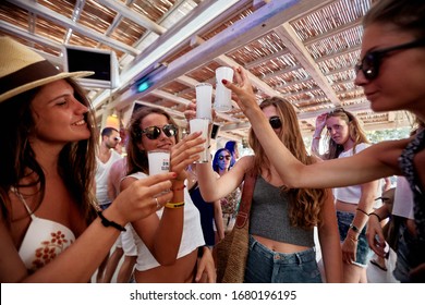 Mykonos, Greece 25 July 2015 Girls Are  In The Beach Party And Drinking Yeni Raki As A Apéritif Which Is A Sweetened, Often Anise-flavoured, Alcoholic Drink From Turkey. Popular In Greece And Balkans