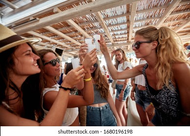 Mykonos, Greece 25 July 2015 Girls Are  In The Beach Party And Drinking Yeni Raki As A Apéritif Which Is A Sweetened, Often Anise-flavoured, Alcoholic Drink From Turkey. Popular In Greece And Balkans