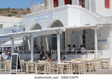 Mykonos, Greece - July 25 2012: Greek Taverna. Summer Time. Travel. People Eating Seafood In Greek Taverna On Beach 