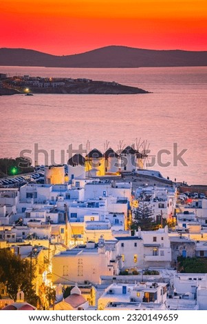 Mykonos, Greece. Sunset over Aegean Sea and the famous windmill from above, Mykonos Island, Cyclades archipelago.