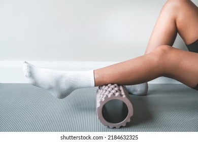 Myofascial release,Massaging fascia calf muscles with myofascial roll, fitness,self-care,health,smart fitness.Myofascial relaxationmuscles of the foot with a massage ball on the mat at home, close-up - Powered by Shutterstock