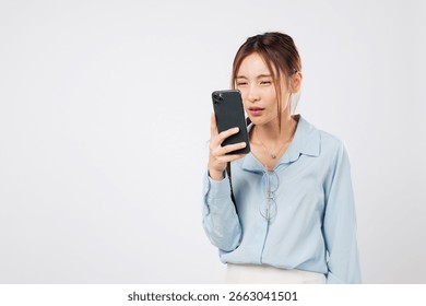 Myopia vision problem. Myopia affects Young Asian woman looking at phone screen closely, eye strain and eyesight loss due to mobile use. isolated studio white background, Poor Eyesight Concept