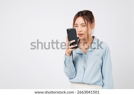 Myopia vision problem. Myopia affects Young Asian woman looking at phone screen closely, eye strain and eyesight loss due to mobile use. isolated studio white background, Poor Eyesight Concept