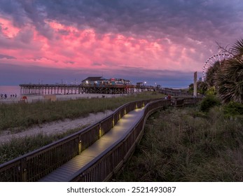 Myrtle Beach boardwalk with Pier 41 restaurant, sand dunes dreamy colorful sunset sky in South Carolina USA - Powered by Shutterstock