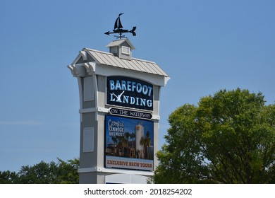 Myrtle Beach, SC - United States - 07-05-2021: A Sign For Barefoot Landing Against A Blue Sky. 