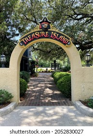 Myrtle Beach, SC USA - September 5, 2021: Front View Of Treasure Island Mini Golf Entrance Sign With Logo And Trees On The Background