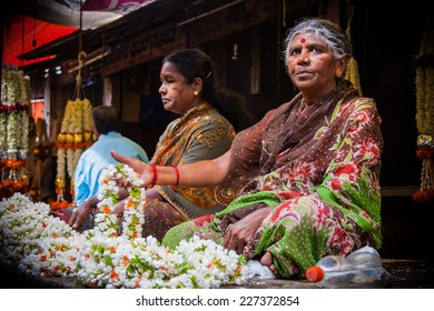 MYSORE, INDIA -  JULY 24th Two Ladies Selling Flower Garlands In The Mysore Marketplace On 24th July 2010