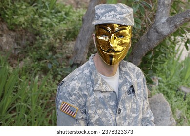 Mysterious army soldier wearing a golden mask 