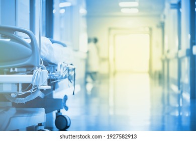 Mysterious, enchanting light in a hospital hallway with a bed in the foreground. - Shutterstock ID 1927582913