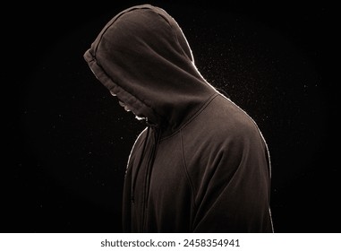 Mysterious figure in hood with glittering backdrop - Powered by Shutterstock