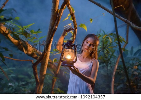 Mysterious Forest Nymph,Medieval Woman with Vintage Lantern Outside at Night ,girl holding a lamp