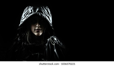 Mysterious Girl In A Hood On A Black Background.