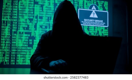 A mysterious hacker wearing a hood, working on a laptop in a dark room with glowing green binary code in the background. The screen shows a security breach warning, creating a cyberpunk atmosphere. - Powered by Shutterstock - Get 15% off with code: PIKWIZARD15