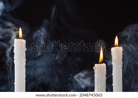 Mysterious Halloween background with candles. Halloween greeting card.