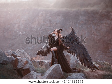 mysterious lady in black light lace dress with long train, girl with open leg in leather boots, dark horned angel from heaven, messenger of death with large wings on edge with closed eyes in sun rays