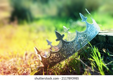 Mysterious And Magical Photo Of Silver King Crown In The Woods. Medieval Period Concept.