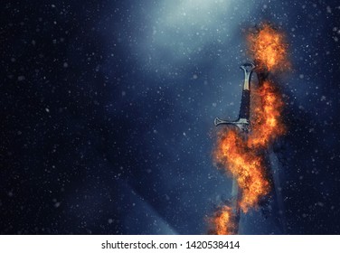 mysterious and magical photo of silver sword over gothic snowy black background. Medieval period concept