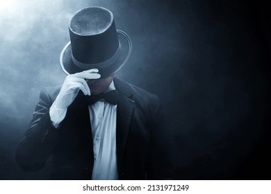 Mysterious man in black suit on dark background