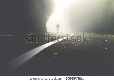 mysterious man walking in the mist