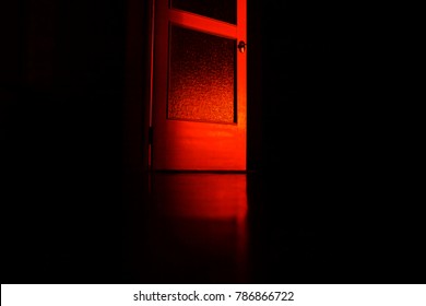 Mysterious Red Door On Black Background
