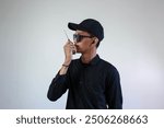 mysterious security forces wearing all black clothing starting from black glasses, hats, shirts are communicating via intercom via walkie talkie isolated on a white background