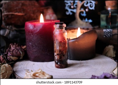 Mysterious Witch's Spell Closed In A Small Glass Bottle With Dried Roses And Magic Candles