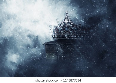 mysteriousand magical image of old crown and book over gothic black background. Medieval period concept - Shutterstock ID 1143877034