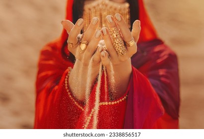 Mystery arabic woman beauty golden mask veil niqab hide face hands close-up with gold metal rings jewelry. Fantasy girl art photo fashion model red dress abay asilk scarf. Sand dunes desert - Shutterstock ID 2338856517