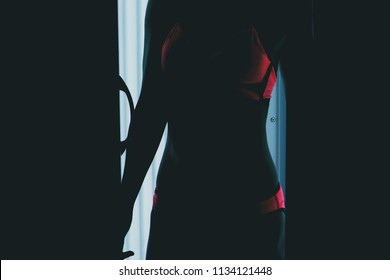 Mystery Woman Looking Through Curtains.
