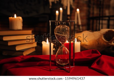 Mystic background with old book, skull, candles. Halloween and occult concept, black magic ritual. There is no foreign text in the image, all symbols are imaginary and fantasy ones