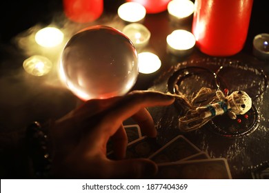 Mystic still life with voodoo doll, the tarot cards, books, evil candles and witchcraft objects. Divination rite.