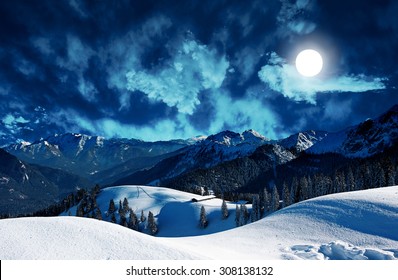 mystic winter landscape in the mountains with full moon - Powered by Shutterstock