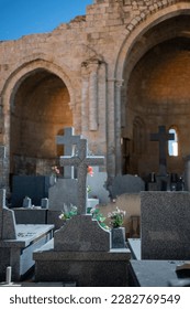 A Mystical and Haunting Scene of an Ancient Chapel Ruins and Graves in a Quiet Cemetery with Gothic Crosses and Tombstones, Symbolizing Faith, Belief, and the Afterlife