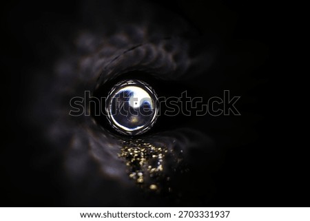 Mystical Light Sphere Surrounded by Darkness and Glittering Particles Inside a Tunnel