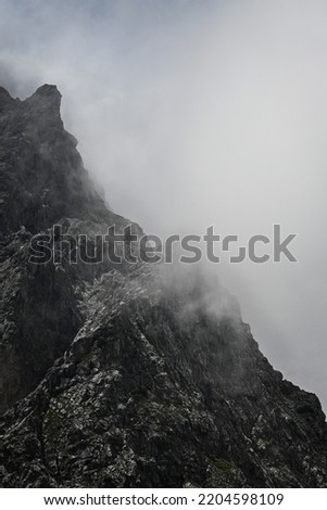 Mystical mountain surrounded by bunch of clouds