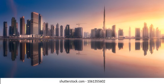 Mystical panoramic view of Dubai Business bay with purple sunrise, UAE - Powered by Shutterstock