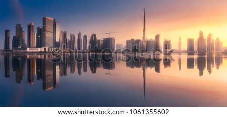 Mystical panoramic view of Dubai Business bay with purple sunrise, UAE