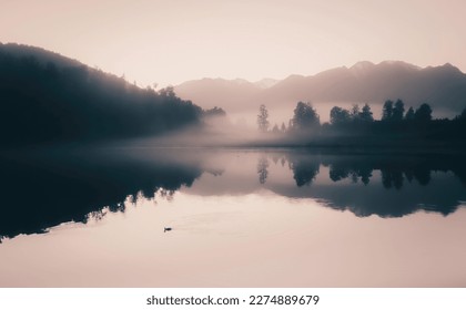 Mystical rising fog, mountain forest landscape with reflections in lake, at reflection island at Lake Matherson in New Zealand - Powered by Shutterstock