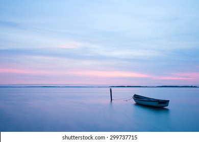 Mystical sea. Abstract natural backgrounds. Moon scene after sunset with still water and vintage boat. - Powered by Shutterstock