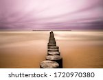 mystical sea/beach with wooden pillars