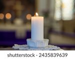 Mystical Serenity: blured altar in Candlelight. Tranquil Reverence.  A white candle, a white candle in the church. a background blurred in the background. in the background, the church