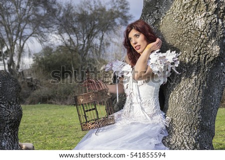 Myth, Beautiful red-haired woman in a forest with a cage containing colored smoke, tale and fantasy image