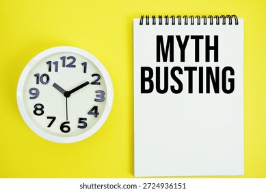 Myth Busting text with alarm clock flat lay on yellow background