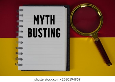 Myth Busting text written on notebook paper with magnifying glass
