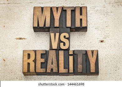 Myth Versus Reality - Concept  In Vintage Letterpress Wood Type On A Grunge Painted Barn Wood Background