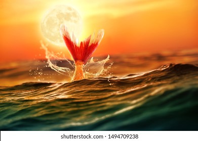 Mythical Mermaid Diving In The Deep Ocean. Night Scene With Full Moon Background.