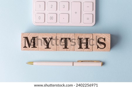 MYTHS on a wooden cubes with pen and calculator, financial concept