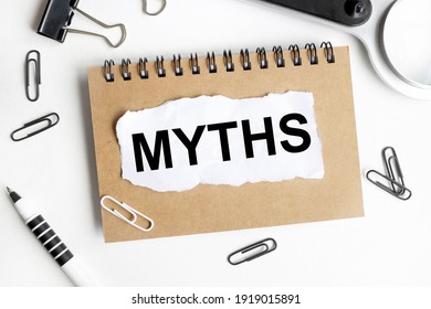 myths. text on white paper over white background. notebook, pen. - Shutterstock ID 1919015891