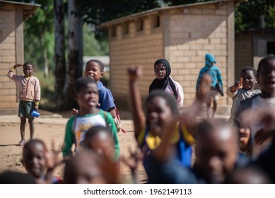 Mzuzu, Malawi. 30-05-2018. Portrait of a young black muslim. girl with a group of children looking at the camera in a rural area of Malawi.